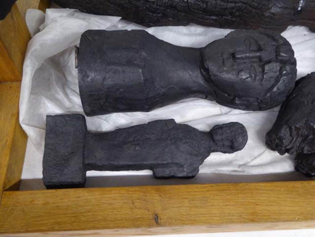 III.13, Herculaneum. September 2016. 
Prof. Andrew Wallace-Hadrill provenanced the larger wooden portrait of a female head, as coming from a room in this house
Photo courtesy of Michael Binns.
According to Maiuri, the head, roughly carved in wood, belonging to the domestic lararium.
See Maiuri, Amedeo, (1977). Herculaneum. 7th English ed, of Guide books to the Museums Galleries and Monuments of Italy, No.53 (p.32).